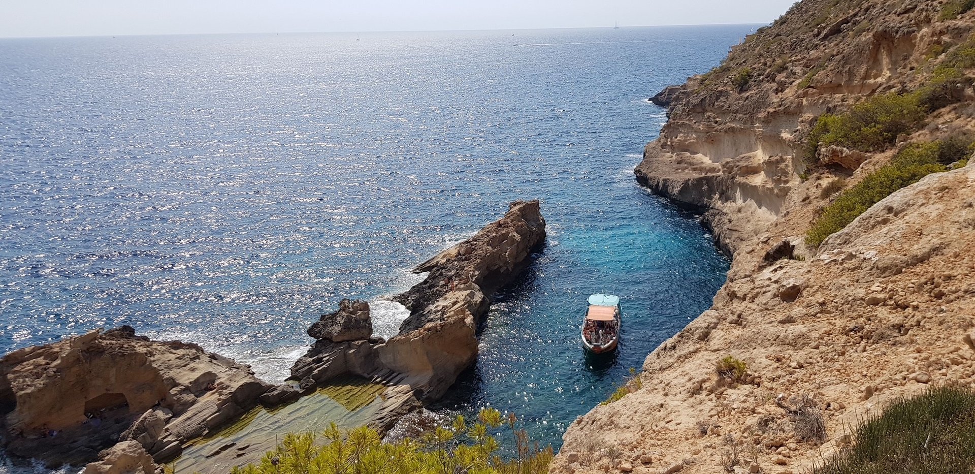 speedboat anchored by one of the cliffs