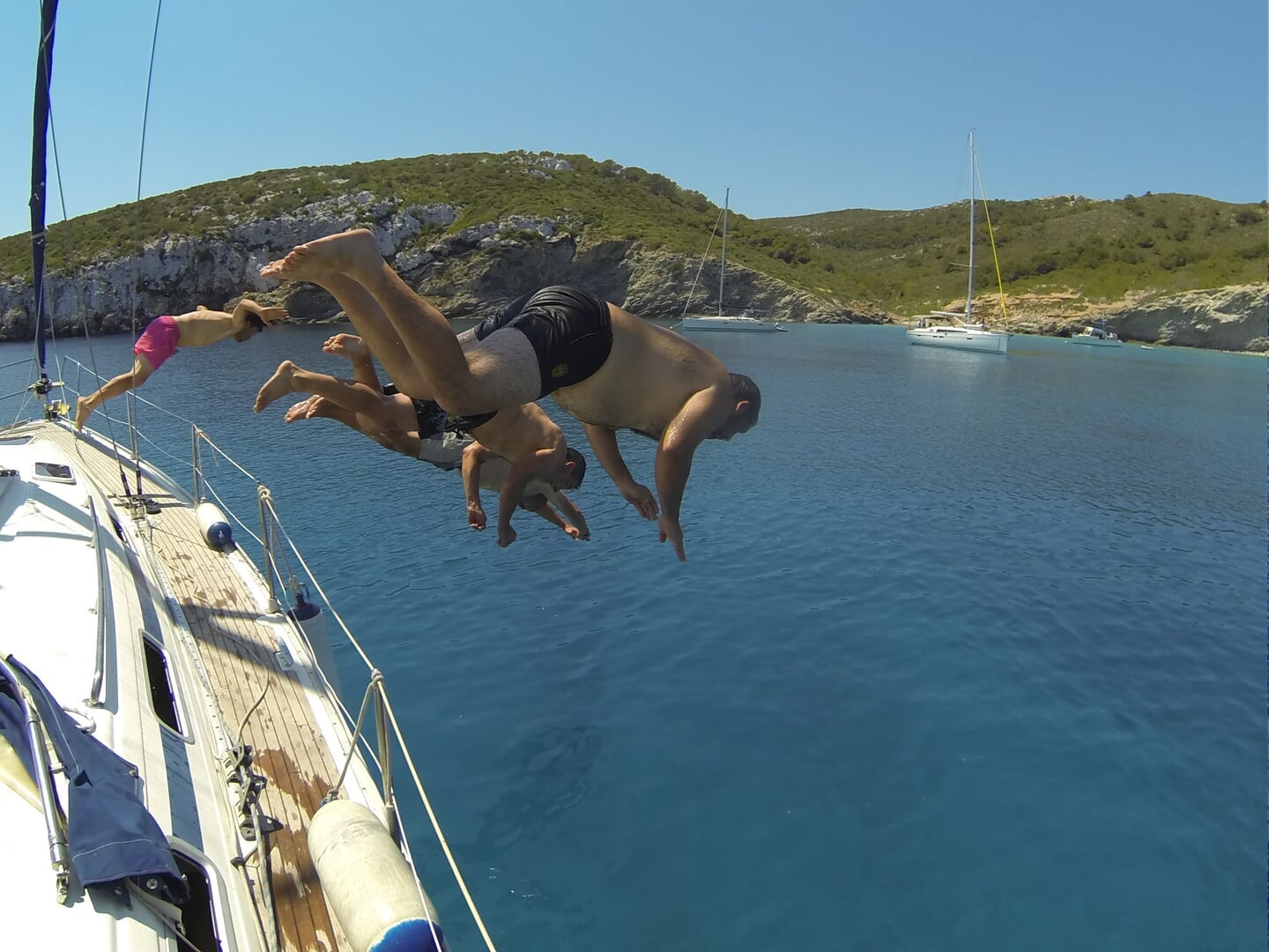 jumping inside the water from the sailing boat